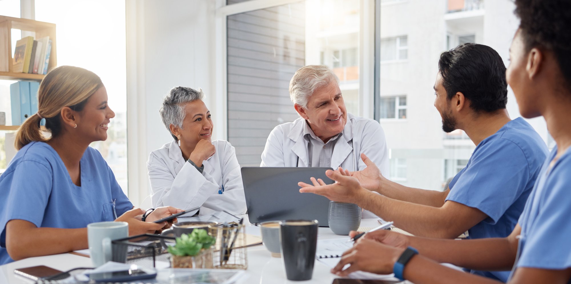 group of health care providers at conference table group of health care providers at conference table